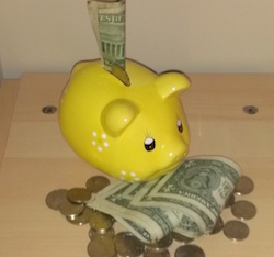 Yellow Piggy Bank with Cash and Coins