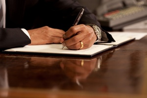 Man Writing in Ledger